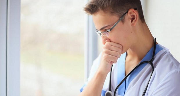 young doctor near window
