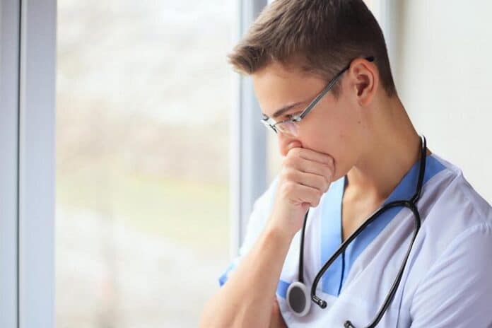 young doctor near window