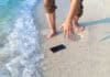 smartphone on the beach, travel insurance, source: Shutterstock