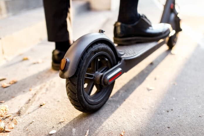 Man's leg on scooter, source: Shutterstock