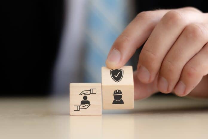 Work insurance and safety dice concept, source: Shutterstock