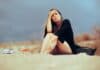 Unhappy woman at the beach, source: Shutterstock