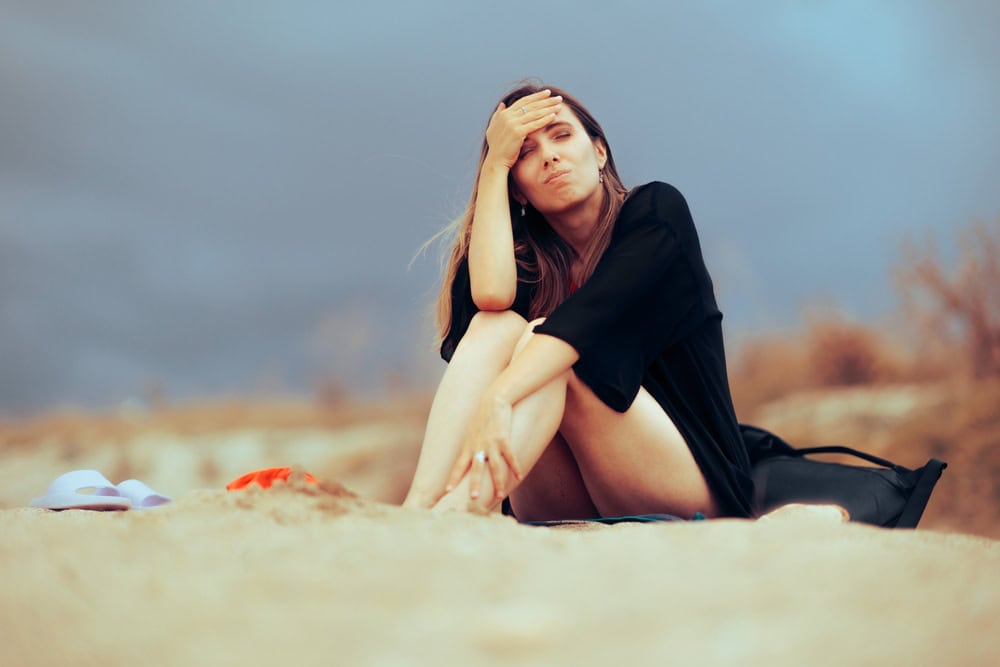 Unhappy woman at the beach, source: Shutterstock