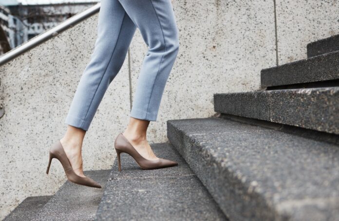 Businesswoman going up stairs, source: Shutterstock