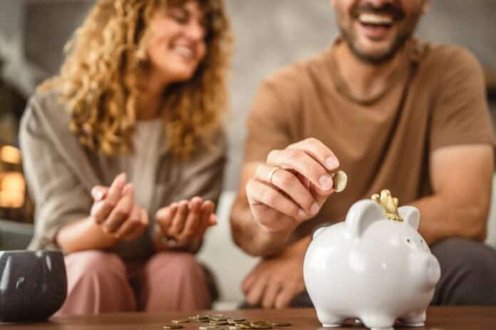 young couple saving money, source: Shutterstock