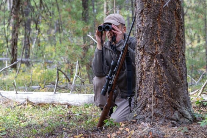 Hunter with binoculars, source: Shutterstock
