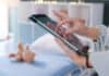 Pediatrician with tablet and teddy bear, source: Shutterstock