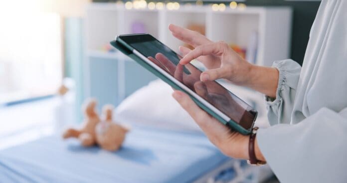 Pediatrician with tablet and teddy bear, source: Shutterstock