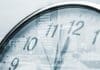 Time concept, clock and corporate buildings, source: Shutterstock