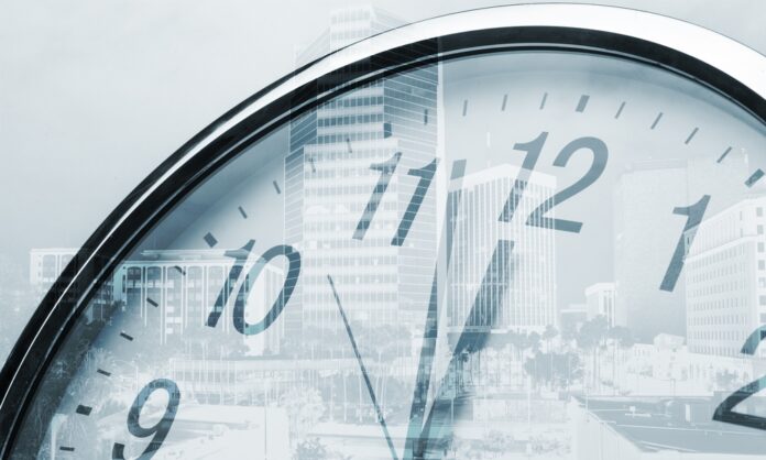 Time concept, clock and corporate buildings, source: Shutterstock