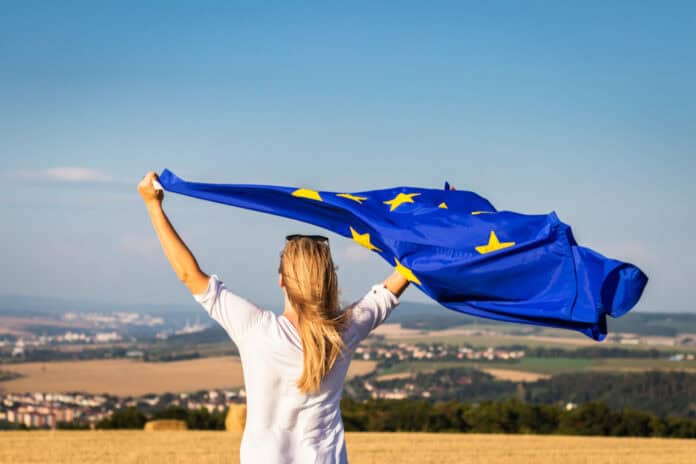 Woman with EU flag, source: Shutterstock