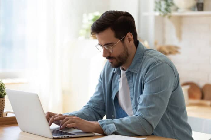 Man at laptop, submitting online application, source: Shutterstock