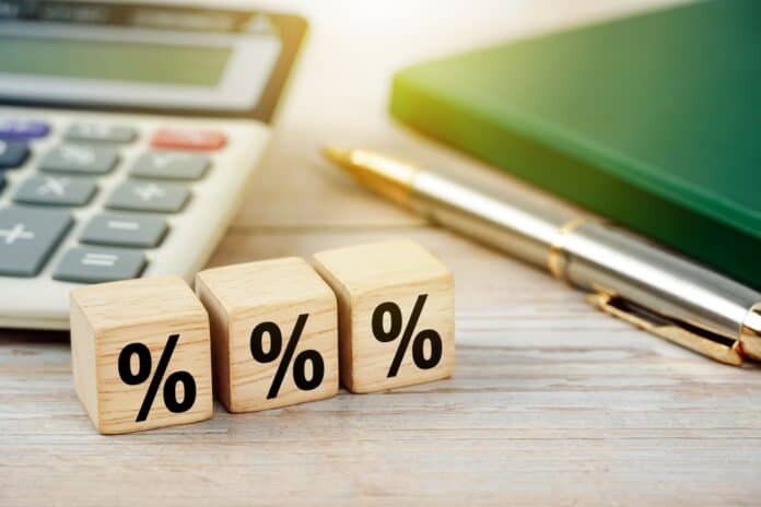 Percentage sign on wooden cubes, business background, source: Shutterstock