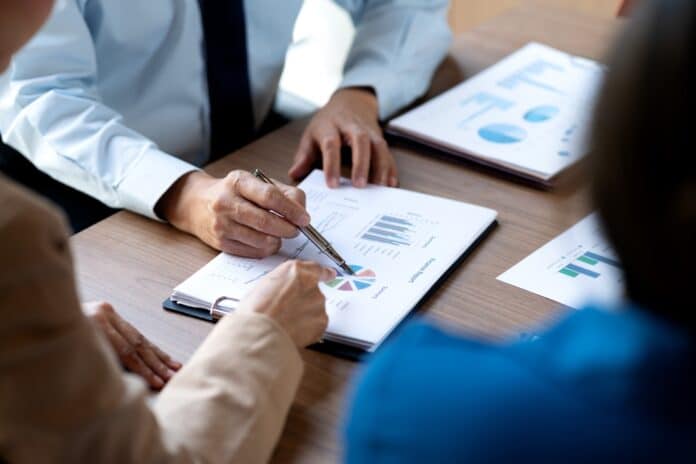 Analyzing data at meeting, source: Shutterstock
