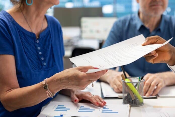 Financial,Expert,Offering,The,Retirement,Plan,Contract,To,Mature,People, People at pension consultation, source: Shutterstock