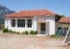The abandoned elementary school building in Vlachia village, North Evia, Greece, source: kokixx / Shutterstock.com