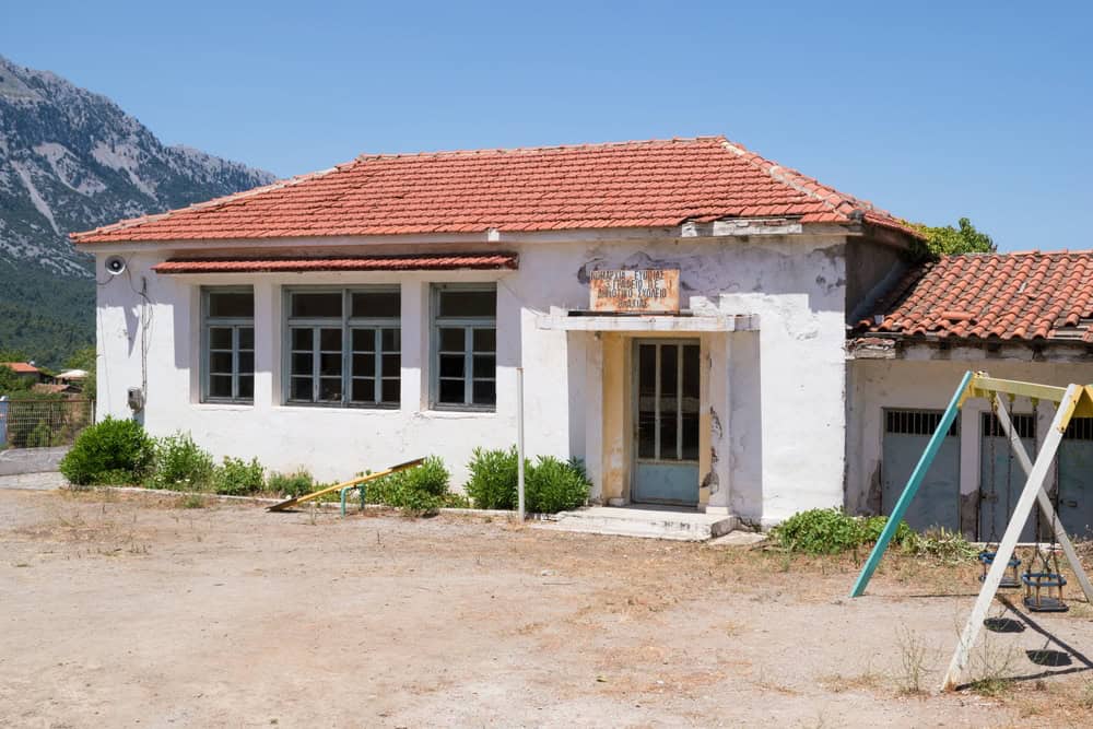 The abandoned elementary school building in Vlachia village, North Evia, Greece, source: kokixx / Shutterstock.com