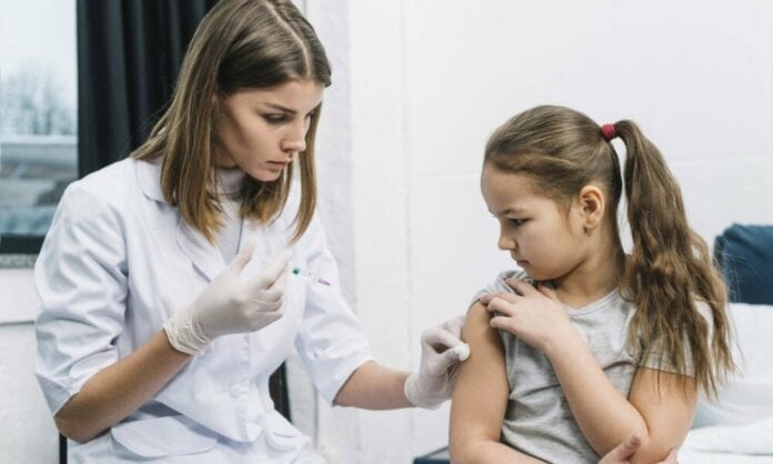 Child vaccinated by pediatrician