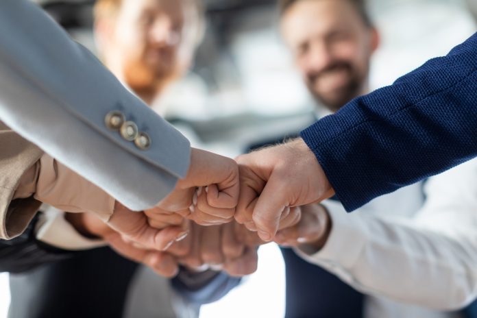 Cropped,Of,A,Business,Teams,Hands,Clasped,Together,In,A team-unity concept, source: Shutterstock