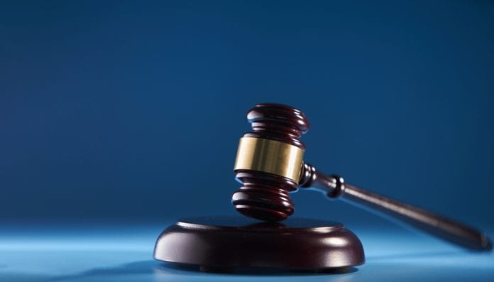 Justice concept, gavel hammer against blue background, source: Shutterstock