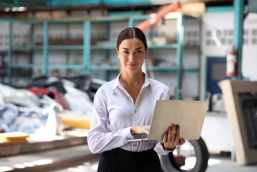 Business insurance concept, woman with laptop at enterprise, source: Shutterstock