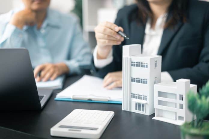 Real,Estate,Agent,,Skilled,In,Finance,And,Business,,Took,On Real estate office concept, source: Shutterstock