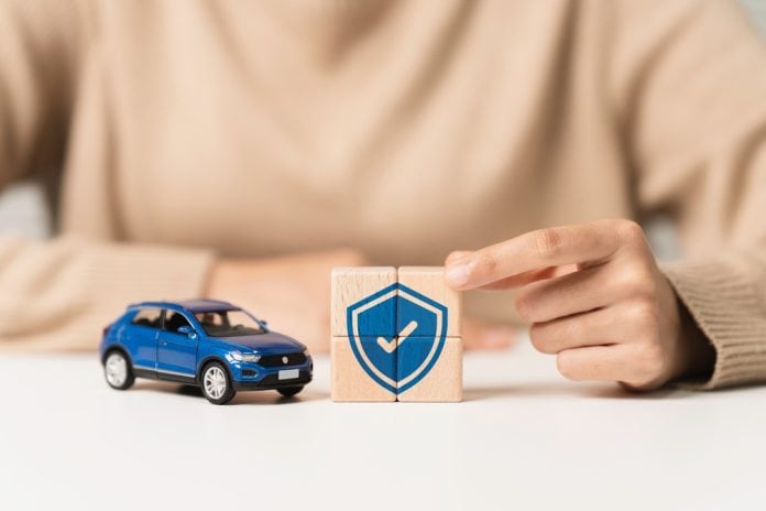 Car,Insurance,,Vehicle,Protection,Concept.,Woman,Holding,Wooden,Blocks,With Car insurance concept, source: Shutterstock