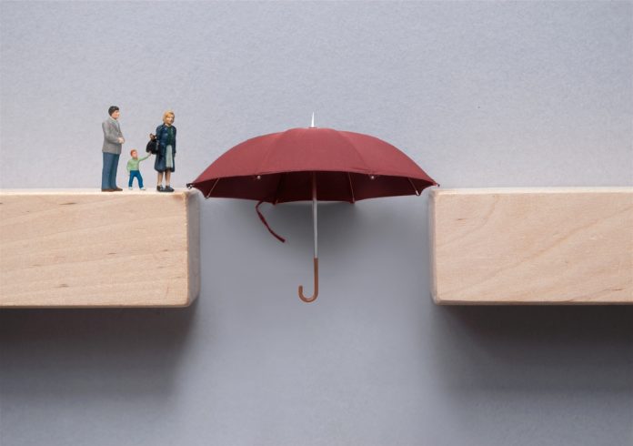 Protection gap closing concept, with figures, umbrella and wooden blocks, source: Shutterstock