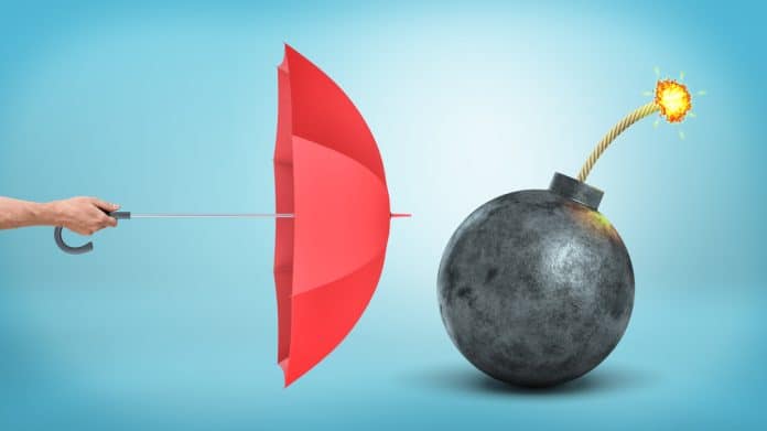 Umbrella and bomb, insurance at war times concept, source: Shutterstock