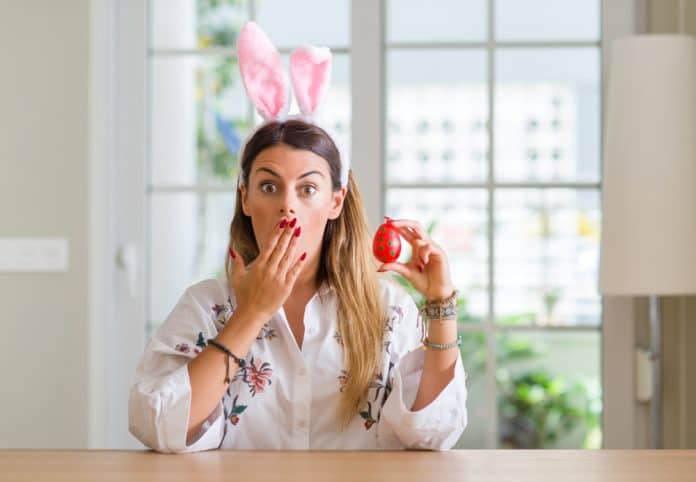 Surprised woman with bunny ears and easter egg, source: Shutterstock
