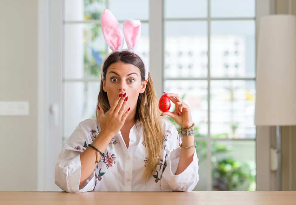 Surprised woman with bunny ears and easter egg, source: Shutterstock