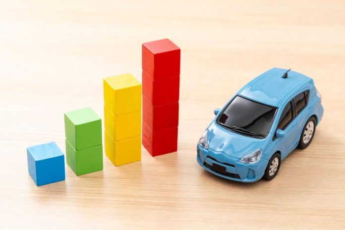 Building,Block,Graph,And,Electric,Car. car statistics concept with toy car and wooden cubes, source: Shutterstock