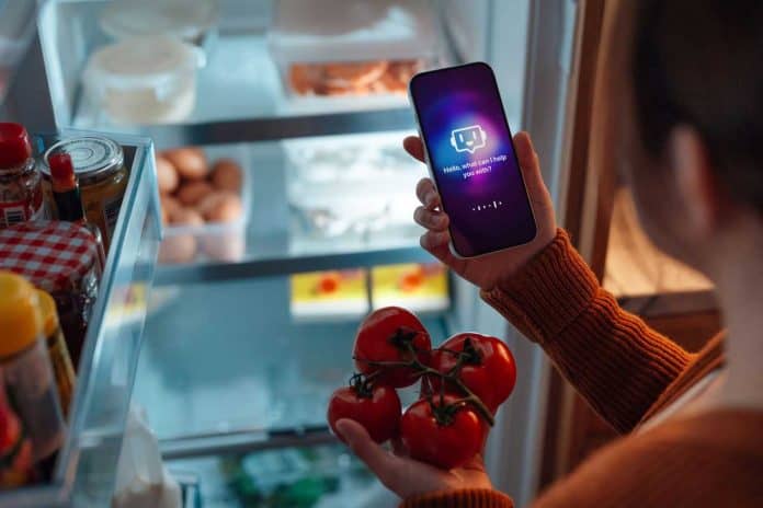 EY, AI report cover image, woman with smartphone and tomatoes standing at the fridge