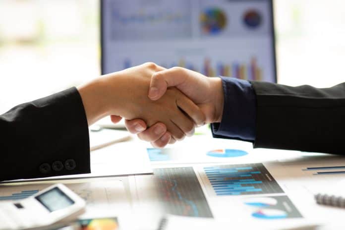 Handshake and statistics, deal concept, source: Shutterstock