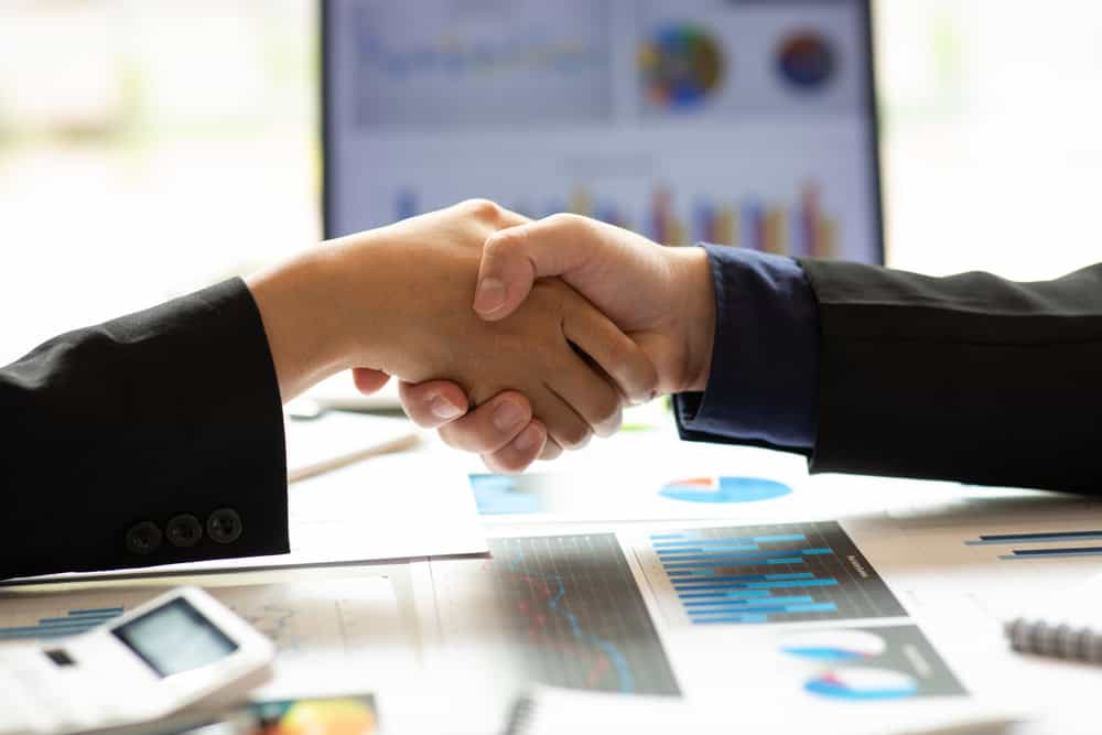 Handshake and statistics, deal concept, source: Shutterstock