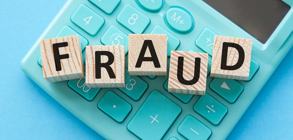 Fraud, word on wooden blocks, on calculator, source: Shutterstock