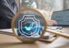 Car safety concept, man at laptop and blue car with insurance sign and magnifying glass, source: Shutterstock