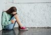 Girl with smartphone crying, cyberbullying concept, source: Shutterstock