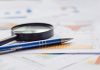Statistics paper, magnifying glass and pen, source: Shutterstock