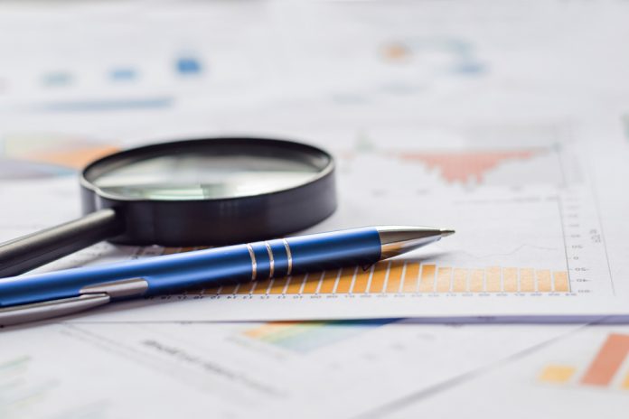 Statistics paper, magnifying glass and pen, source: Shutterstock