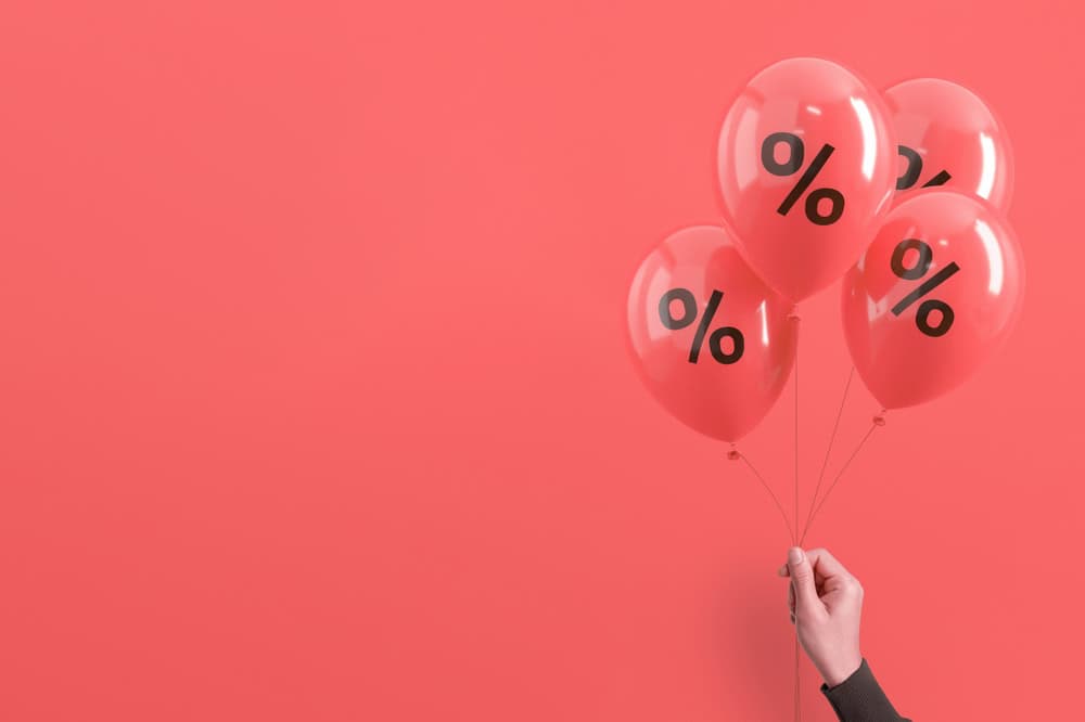 Multiple discount concept with hand holding balloons, source: Shutterstock