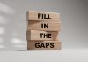 Wooden block with fill in the gaps message, source: Shuterstock