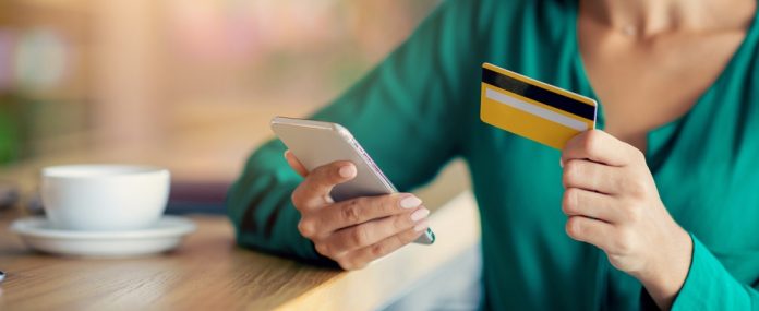 Woman,Using,Smartphone,And,Credit,Card,In,Cafe,For,Online