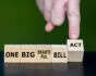Hand turning "One Big Beautiful Bill Act" cubes, image source: Shutterstock