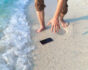 smartphone on the beach, travel insurance, source: Shutterstock
