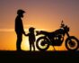 Sunset with motorcyclists, adult and child, wearing helmets, source: Shutterstock