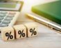 Percentage sign on wooden cubes, business background, source: Shutterstock