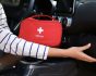 Woman driver holding first aid kit, source: Shutterstock
