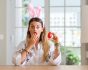 Surprised woman with bunny ears and easter egg, source: Shutterstock