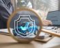 Car safety concept, man at laptop and blue car with insurance sign and magnifying glass, source: Shutterstock